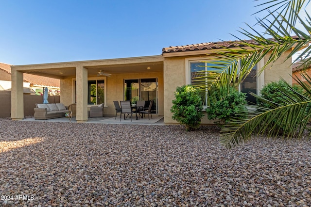 7790 W Noble Prairie Way, Florence, AZ 85132 - back of house featuring an outdoor living space, a patio area, a ceiling fan, fence, and stucco siding