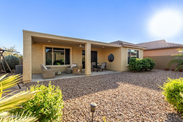 7790 W Noble Prairie Way, Florence, AZ 85132 - back of house featuring a tiled roof, central AC unit, ceiling fan, a patio, and stucco siding