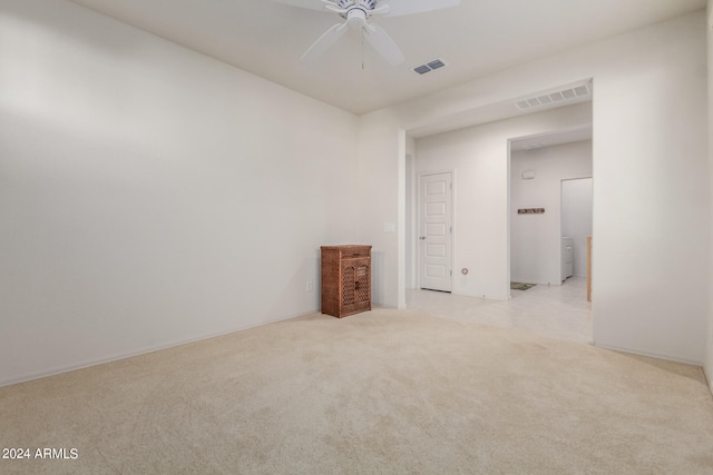 unfurnished room featuring light colored carpet and ceiling fan