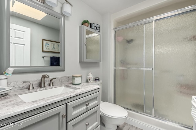 full bathroom featuring vanity, toilet, and a stall shower