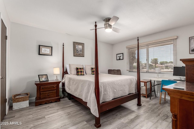 bedroom with baseboards, a ceiling fan, and light wood-style flooring