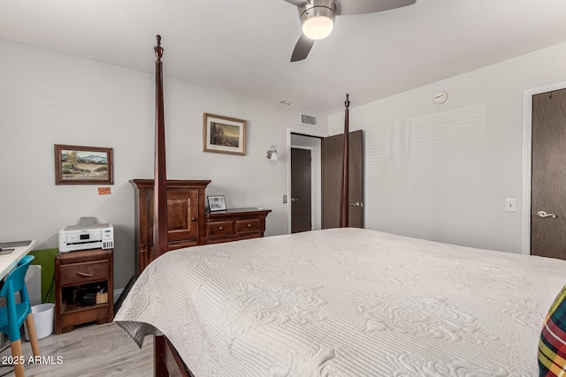 bedroom featuring light wood finished floors, a ceiling fan, and visible vents