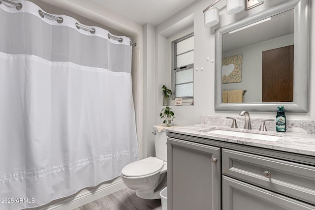full bathroom with toilet, vanity, wood finished floors, and curtained shower