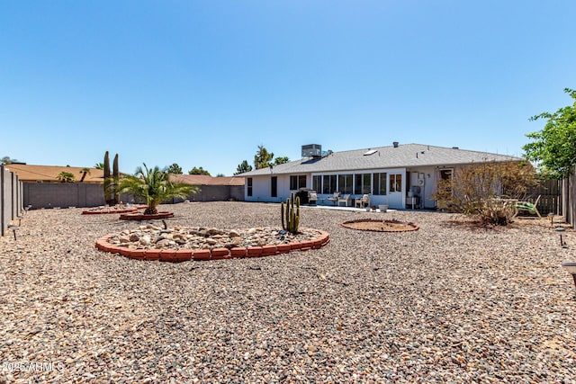 back of property with a patio area and a fenced backyard