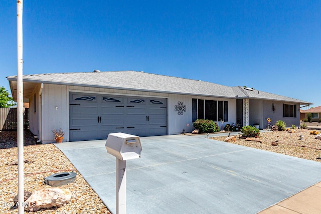 single story home with an attached garage, fence, and concrete driveway