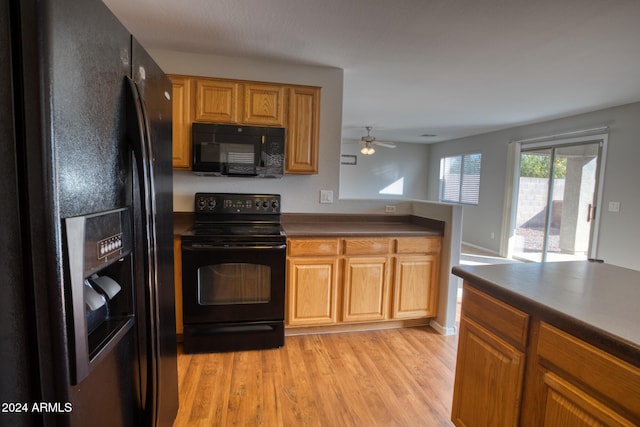 kitchen featuring black appliances, ceiling fan, and light wood-type flooring