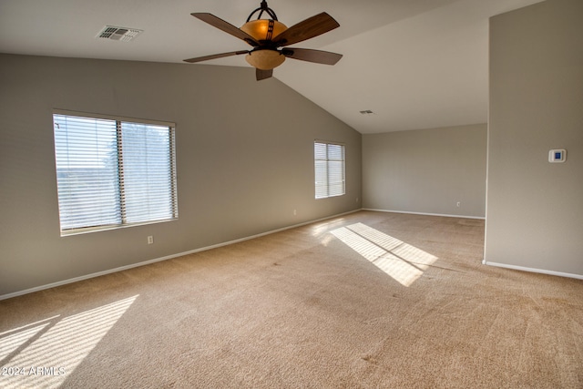 empty room with light colored carpet, ceiling fan, and lofted ceiling