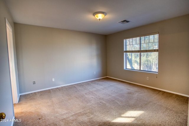 empty room featuring light carpet