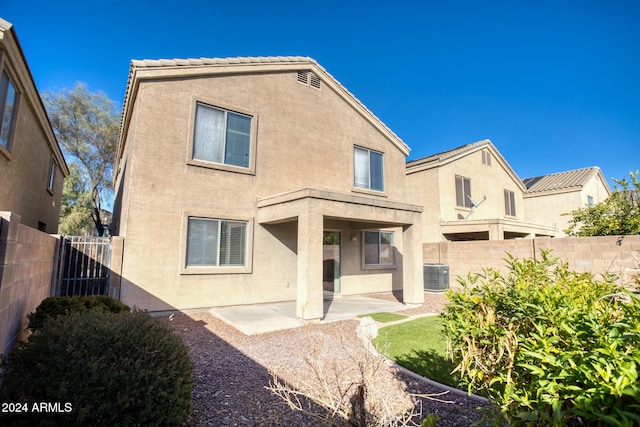 rear view of house with a patio and central AC unit