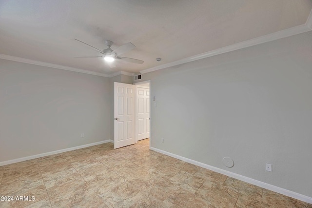 empty room with ceiling fan and crown molding