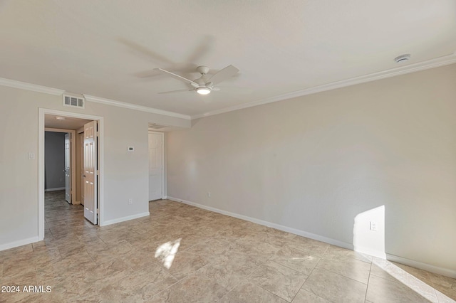 spare room with ceiling fan and crown molding