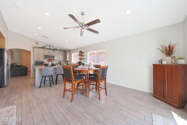11207 W Turney Ave, Phoenix, AZ 85037 - dining area featuring arched walkways, ceiling fan, vaulted ceiling, light wood-type flooring, and recessed lighting