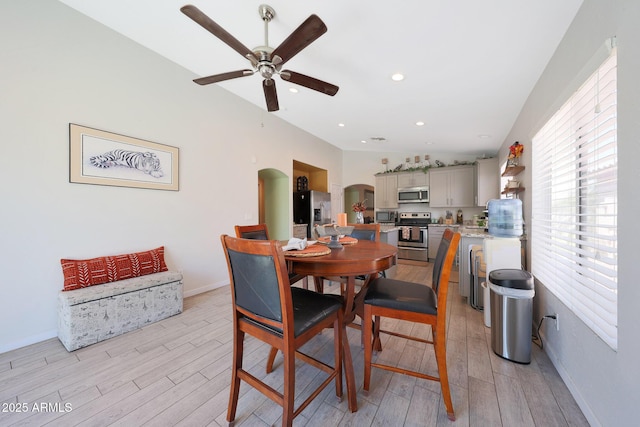 11207 W Turney Ave, Phoenix, AZ 85037 - dining space featuring arched walkways, light wood-type flooring, a ceiling fan, and baseboards