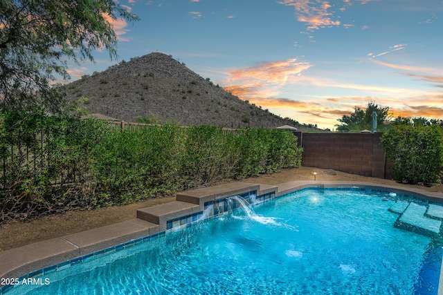 1812 E Parkside Ln E, Phoenix, AZ 85024 - pool at dusk with a fenced backyard and a mountain view