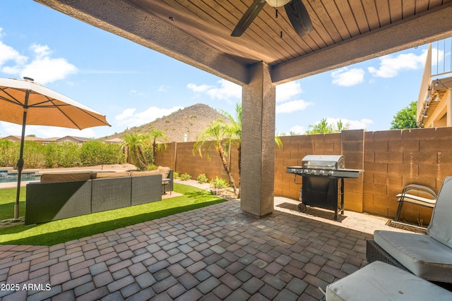 1812 E Parkside Ln E, Phoenix, AZ 85024 - fenced backyard featuring area for grilling, an outdoor hangout area, a patio area, a ceiling fan, and a mountain view