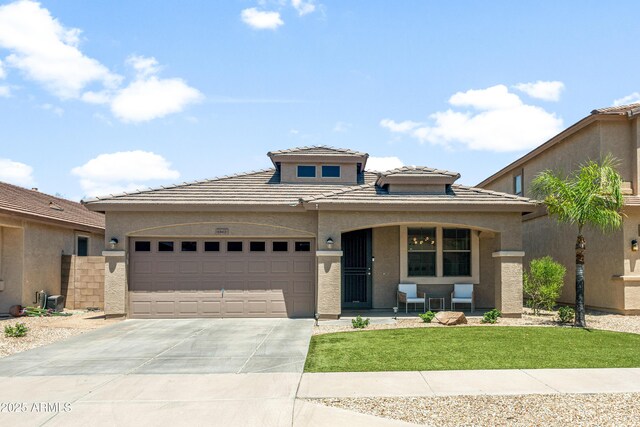 1812 E Parkside Ln E, Phoenix, AZ 85024 - view of front of home featuring concrete driveway, an attached garage, stucco siding, and a tile roof
