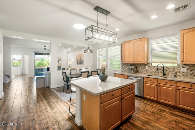 1812 E Parkside Ln E, Phoenix, AZ 85024 - kitchen with stainless steel dishwasher, dark wood-style flooring, decorative backsplash, light countertops, and a kitchen island