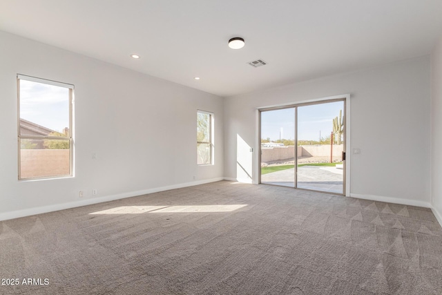 spare room with light carpet, baseboards, visible vents, and recessed lighting