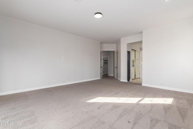 unfurnished room featuring carpet floors and baseboards
