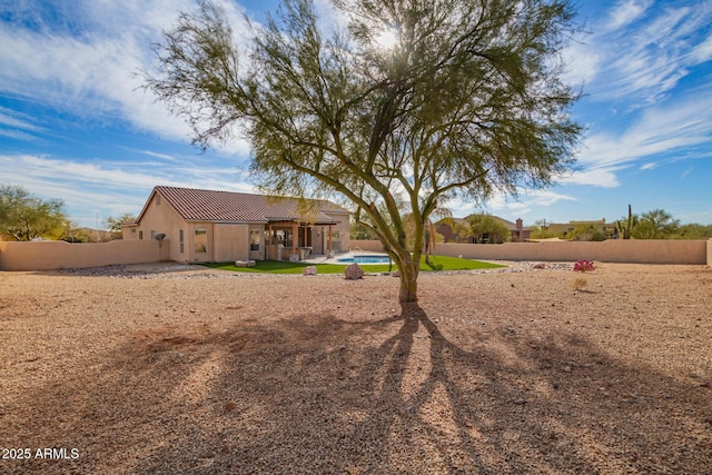 exterior space featuring fence, a fenced in pool, and a patio