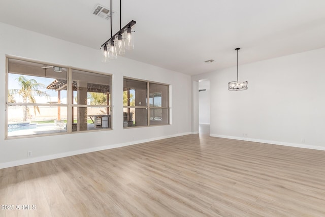 unfurnished dining area featuring light wood-style floors, visible vents, and baseboards