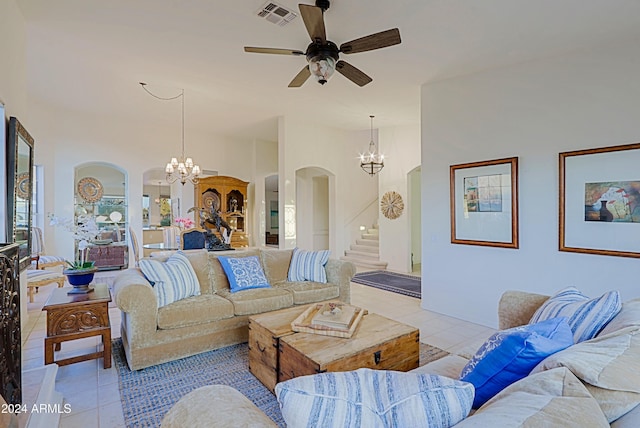 living room featuring light tile patterned floors and ceiling fan with notable chandelier