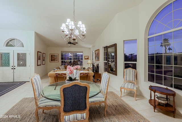 dining space featuring high vaulted ceiling, a notable chandelier, and light tile patterned flooring