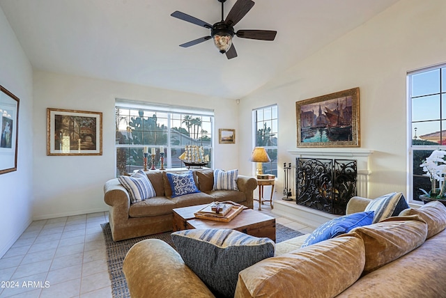 tiled living room featuring ceiling fan and vaulted ceiling