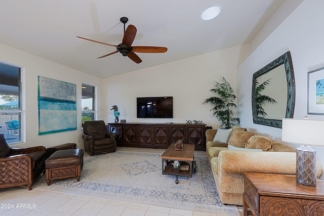 living room featuring light tile patterned floors, vaulted ceiling, and ceiling fan