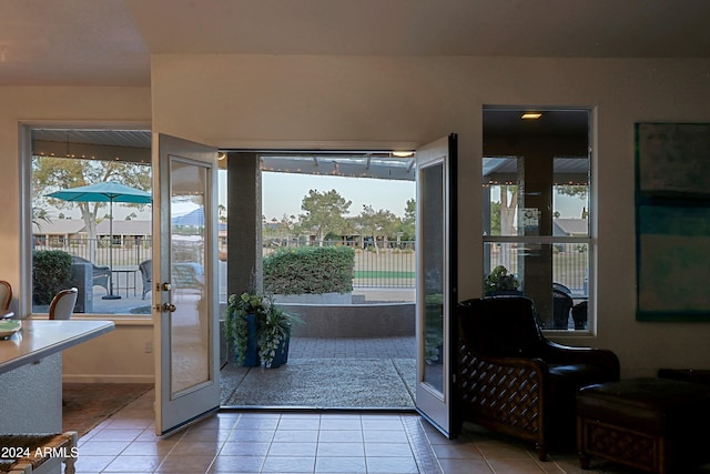 entryway featuring tile patterned floors, french doors, and a healthy amount of sunlight