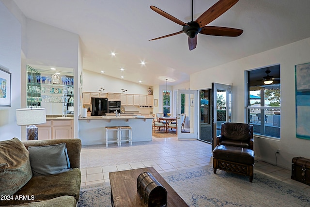 tiled living room with sink and high vaulted ceiling