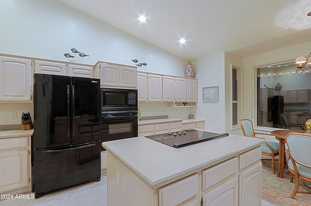 kitchen featuring a center island, lofted ceiling, black appliances, light tile patterned floors, and a notable chandelier