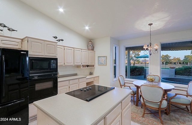 kitchen featuring a center island, a chandelier, decorative light fixtures, vaulted ceiling, and black appliances