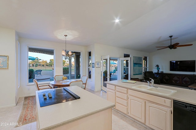 kitchen with sink, a center island, decorative light fixtures, black appliances, and ceiling fan with notable chandelier