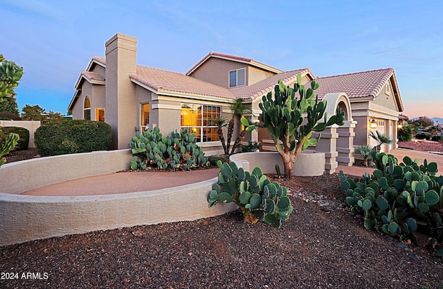 mediterranean / spanish home with a garage