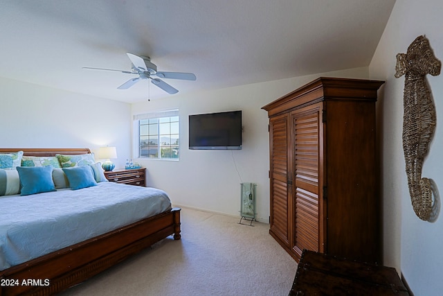 bedroom with ceiling fan and light colored carpet