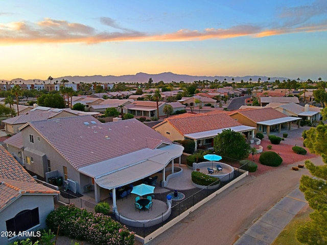 aerial view at dusk featuring a mountain view