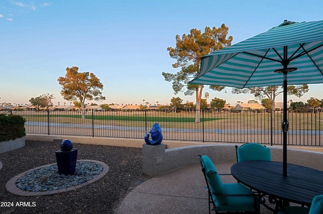 view of patio terrace at dusk