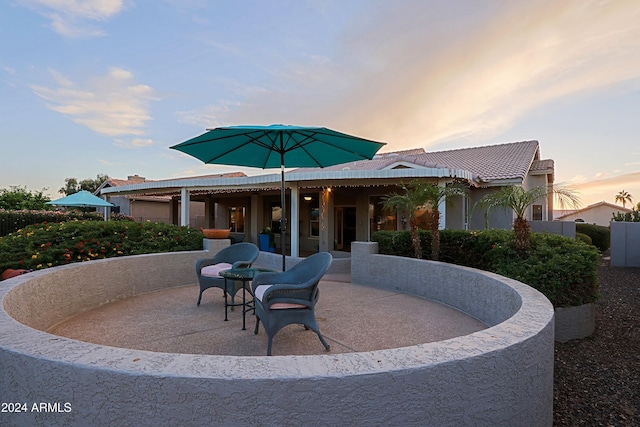 view of patio terrace at dusk