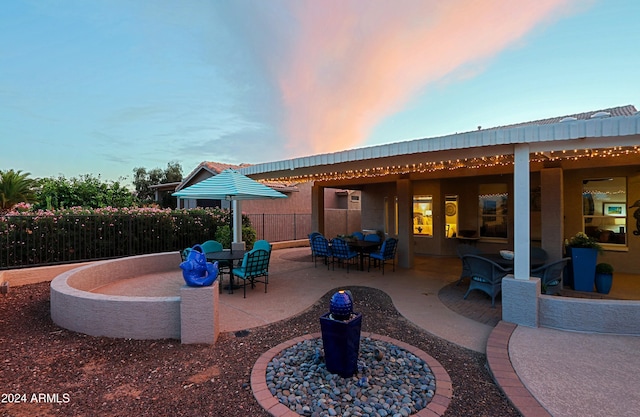 view of patio terrace at dusk