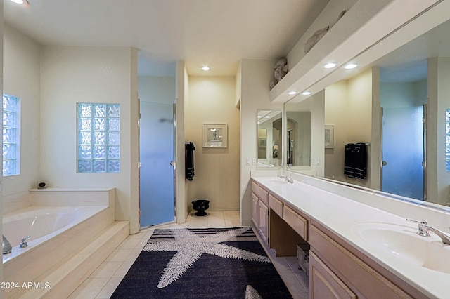 bathroom with plus walk in shower, vanity, and tile patterned floors