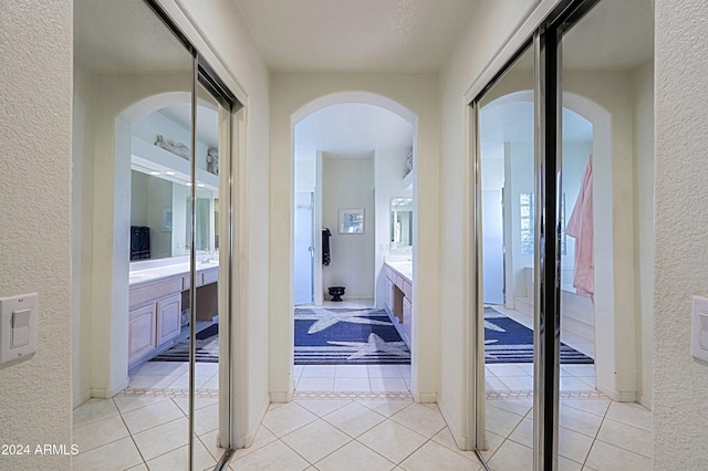 corridor featuring light tile patterned floors