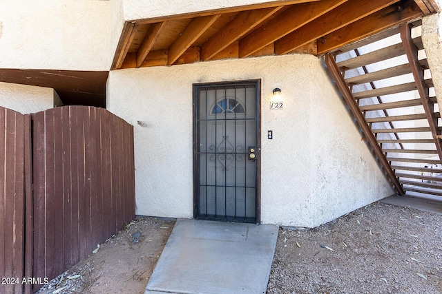 doorway to property featuring stucco siding