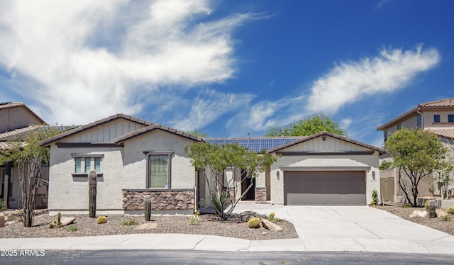 view of front of property with an attached garage, solar panels, driveway, stucco siding, and a tiled roof