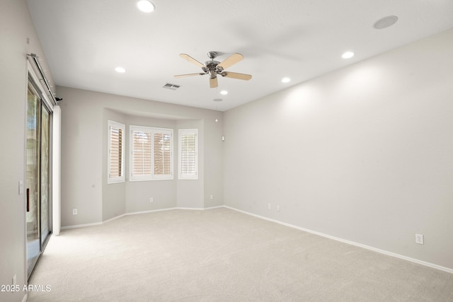 unfurnished room featuring light carpet, a ceiling fan, recessed lighting, baseboards, and healthy amount of natural light