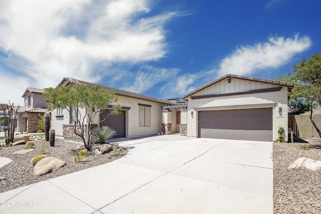 single story home featuring driveway, a garage, stucco siding, and a gate