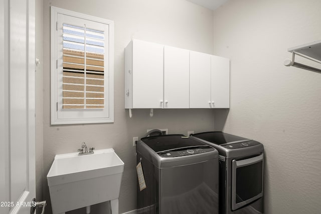 laundry room featuring cabinet space and independent washer and dryer