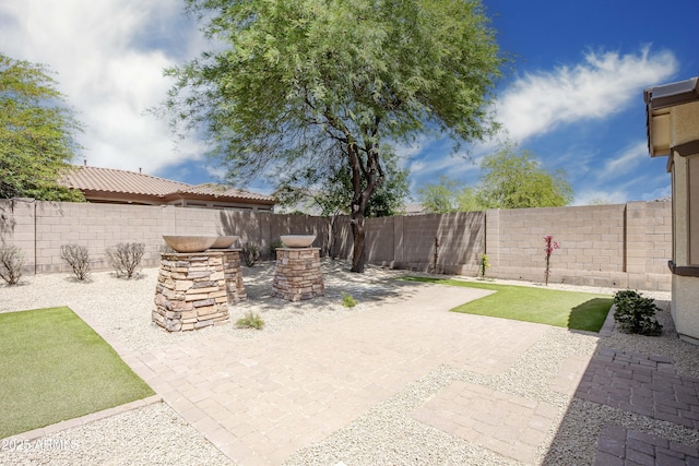 fenced backyard featuring a patio