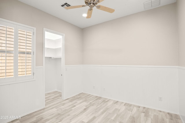 spare room with wood finished floors and ceiling fan