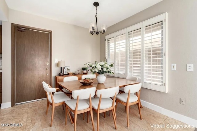 dining area with an inviting chandelier